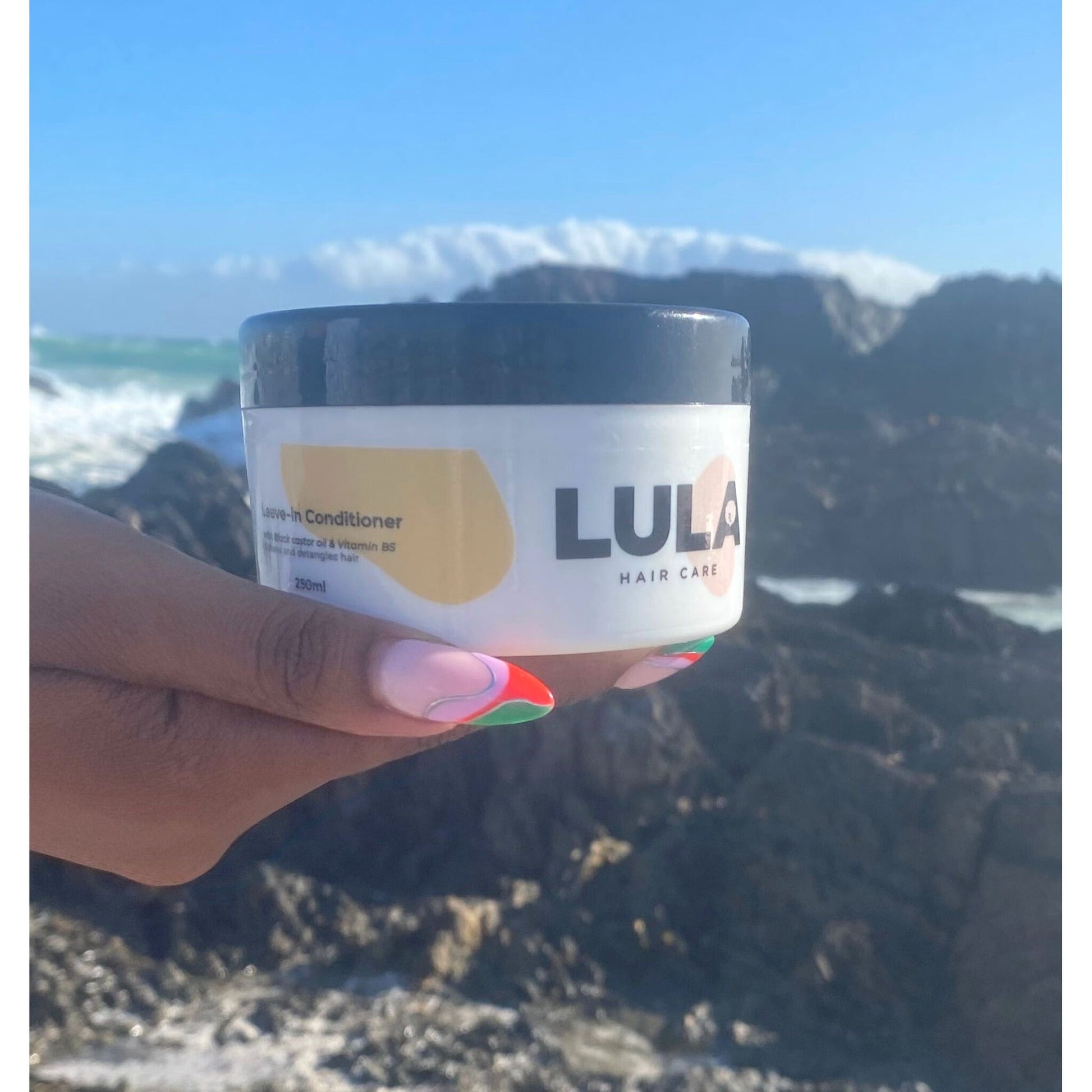 LULA leave-in conditioner in a tub with beach background